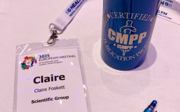 ISMPP 2025 Pass, pen and water bottle on a pink table